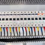 Close-up of an organized residential circuit breaker panel with color-coded wiring
