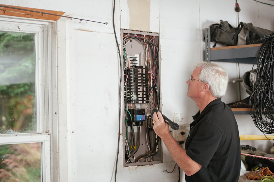 An electrician carefully inspecting a residential fuse box during an emergency service call