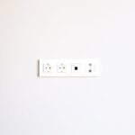 Modern wall outlet array installed on a bright white wall