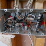 Open electrical switchboard with tangled aged wiring needing rewire