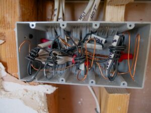 Open electrical switchboard with tangled aged wiring needing rewire