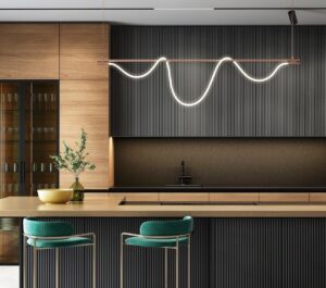 Modern kitchen with layered LED lighting including pendants, recessed lights, and bar stools
